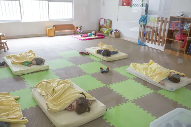 Después del almuerzo, los niños tienen la opción de descansar. Las madres cuidadoras los acunan hasta que concilian el sueño.