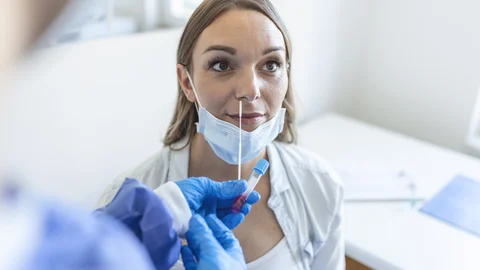 doctor-nurse-taking-pcr-nasal-swab-test-from-pregnant-woman-covid-19-vaccination-concept.jpg