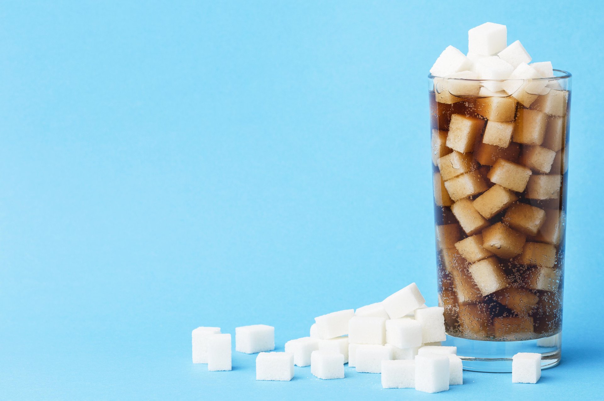 front-view-glass-soft-drink-with-sugar-cubes-copy-space