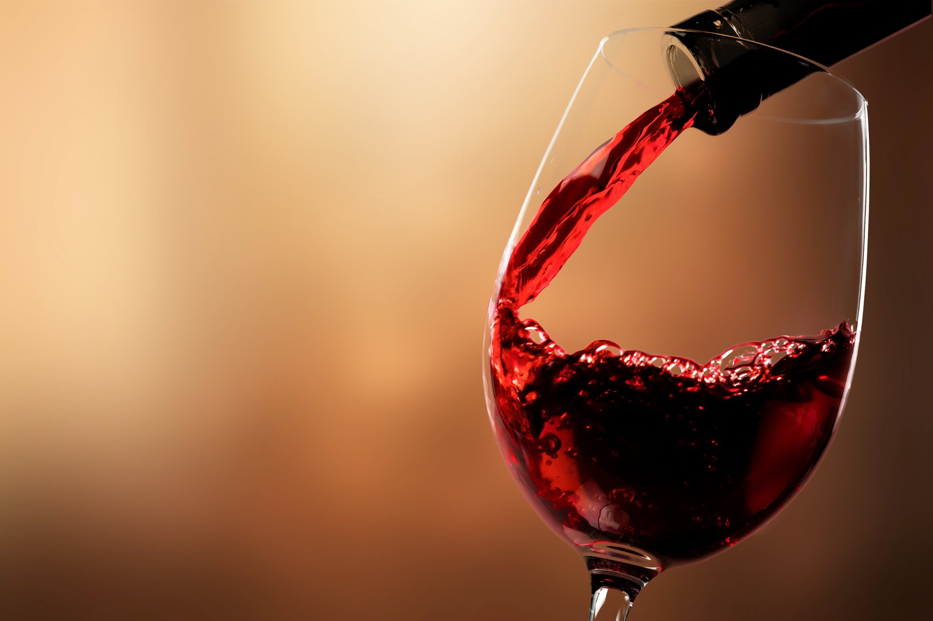 red-wine-pouring-from-bottle-glass