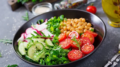 salad-of-chickpeas-tomatoes-cucumbers-radish-and-greens-dietary-food-buddha-bowl-vegan-salad