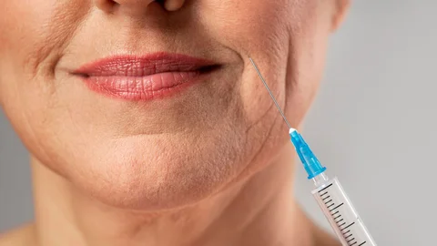 smiley-elder-woman-using-injection-her-mouth-wrinkles